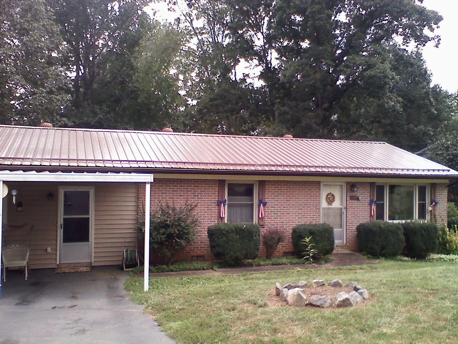 Bronze metal roof and carport on a brick ranch home — Roof Repair work by our crew in Moreno Valley